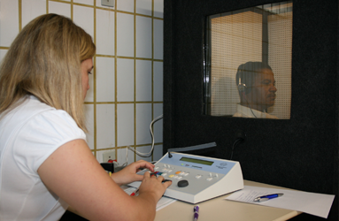 Registered nurse administers a hearing test